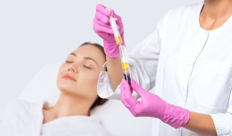Medical professional extracting Platelet-Rich Plasma (PRP) growth factors from a vial to enhance collagen production during a microneedling treatment.